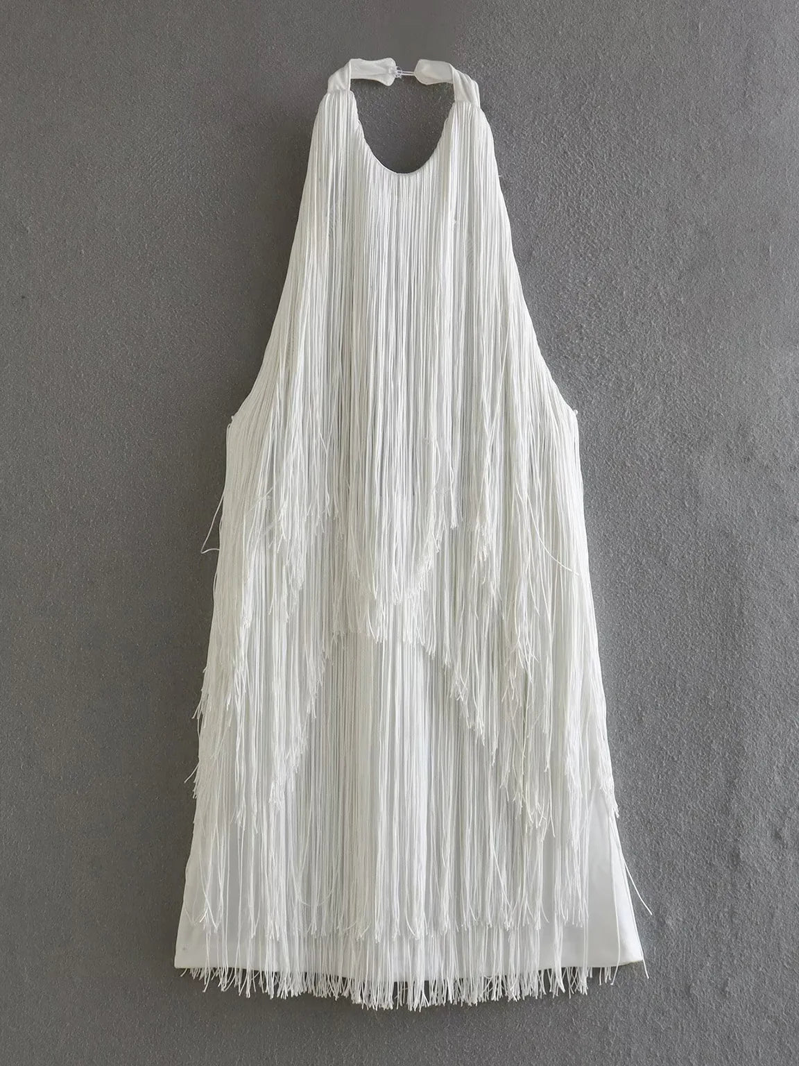 White fringe dress on a gray background. #Color_White