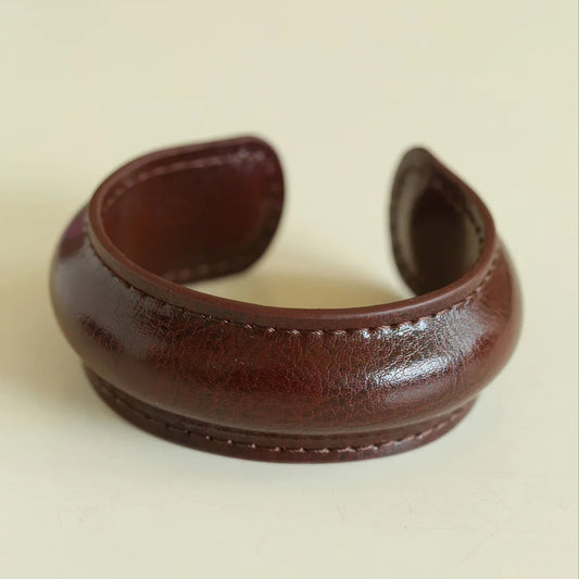 Brown leather cuff on a beige background