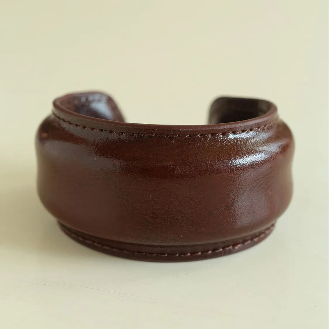 Brown leather cuff on a beige background