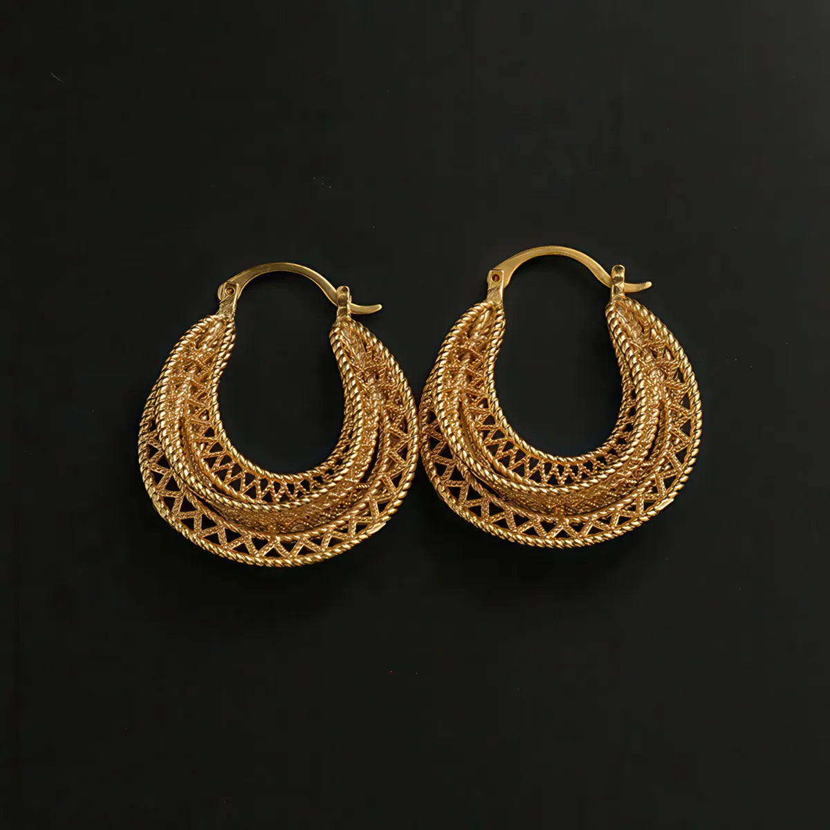 Pair of gold hoop earrings on a black background. #Style_A
