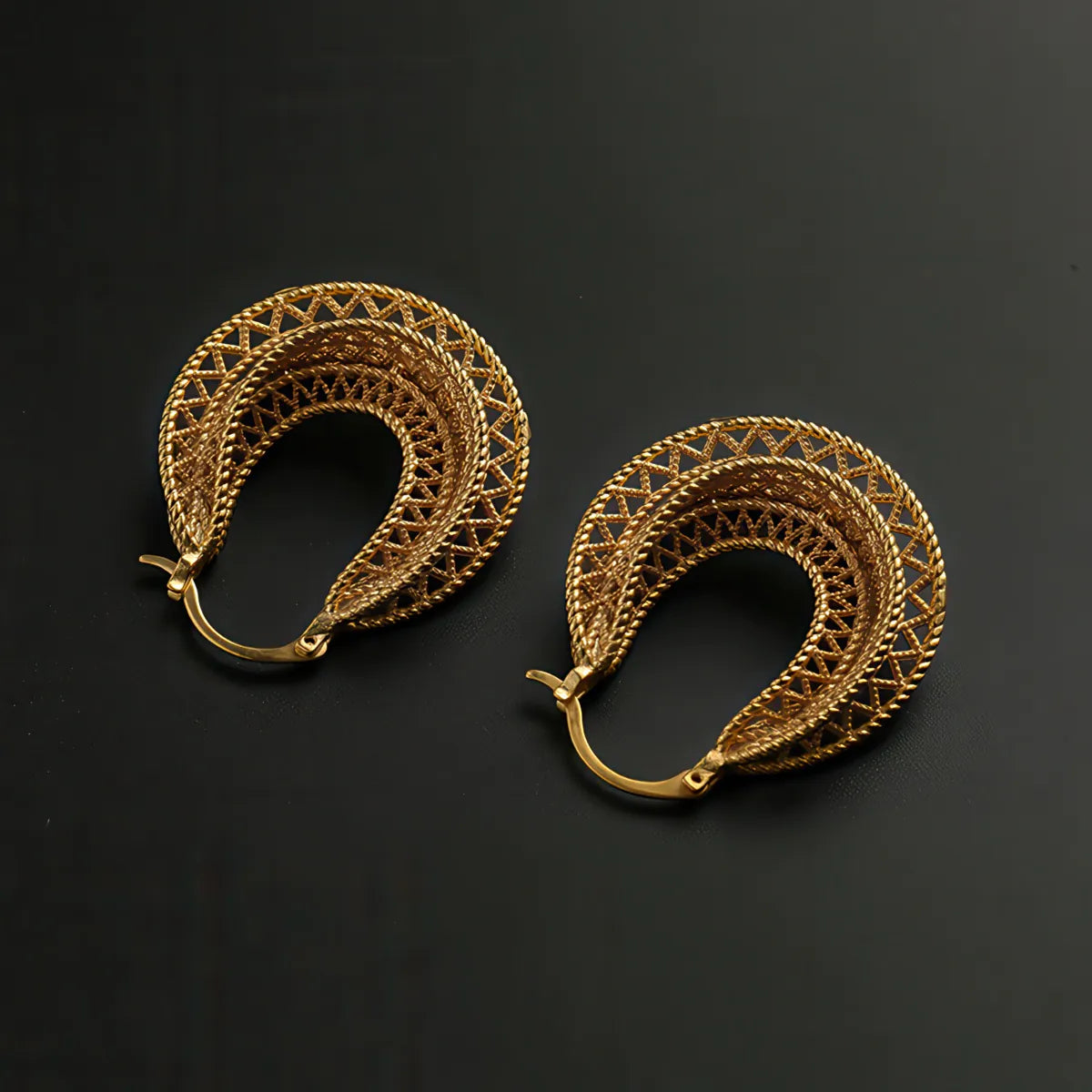 Pair of gold hoop earrings on a black background. #Style_A
