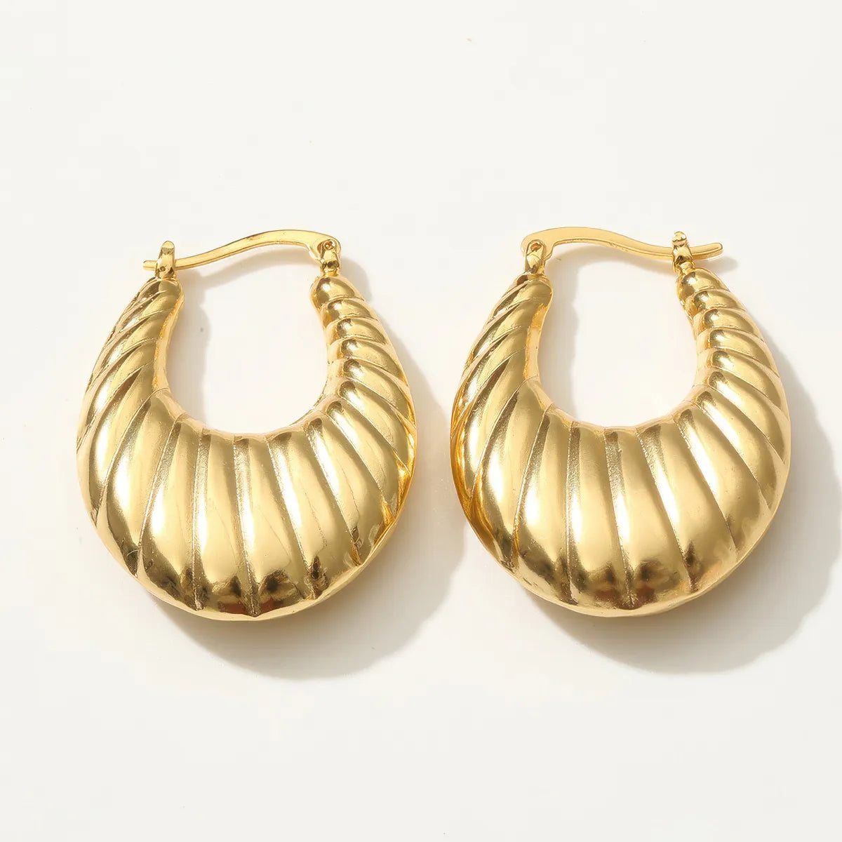 Pair of gold hoop earrings on a white background. #Style_B