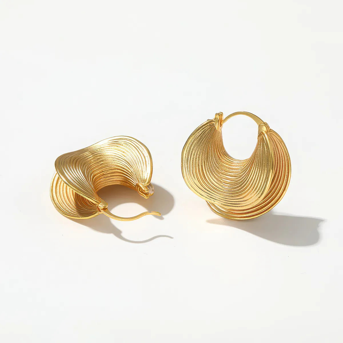 Pair of gold hoop earrings on a white background. #Style_E