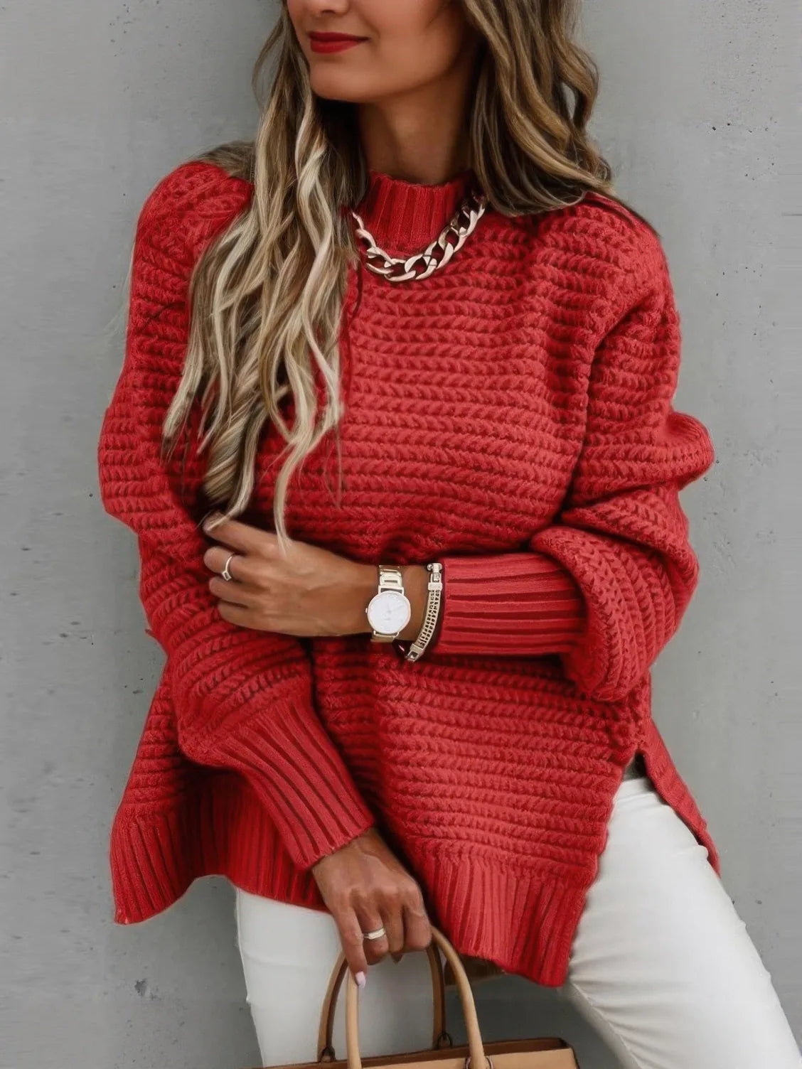 Person wearing a red sweater with a neutral background. #Color_Red