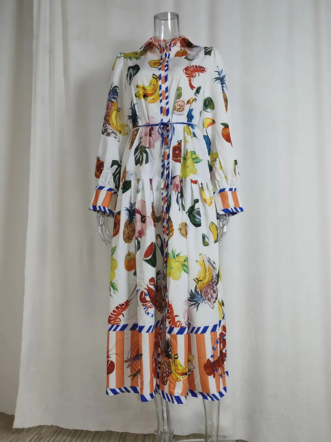 Colorful fruit-patterned dress on a mannequin against a plain background. #Color_White