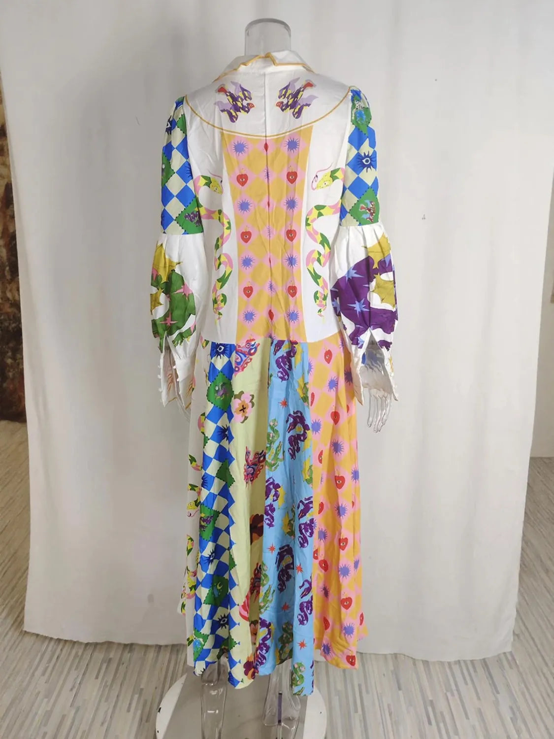 Colorful dress with floral patterns on a mannequin against a white background. #Color_LightBlue