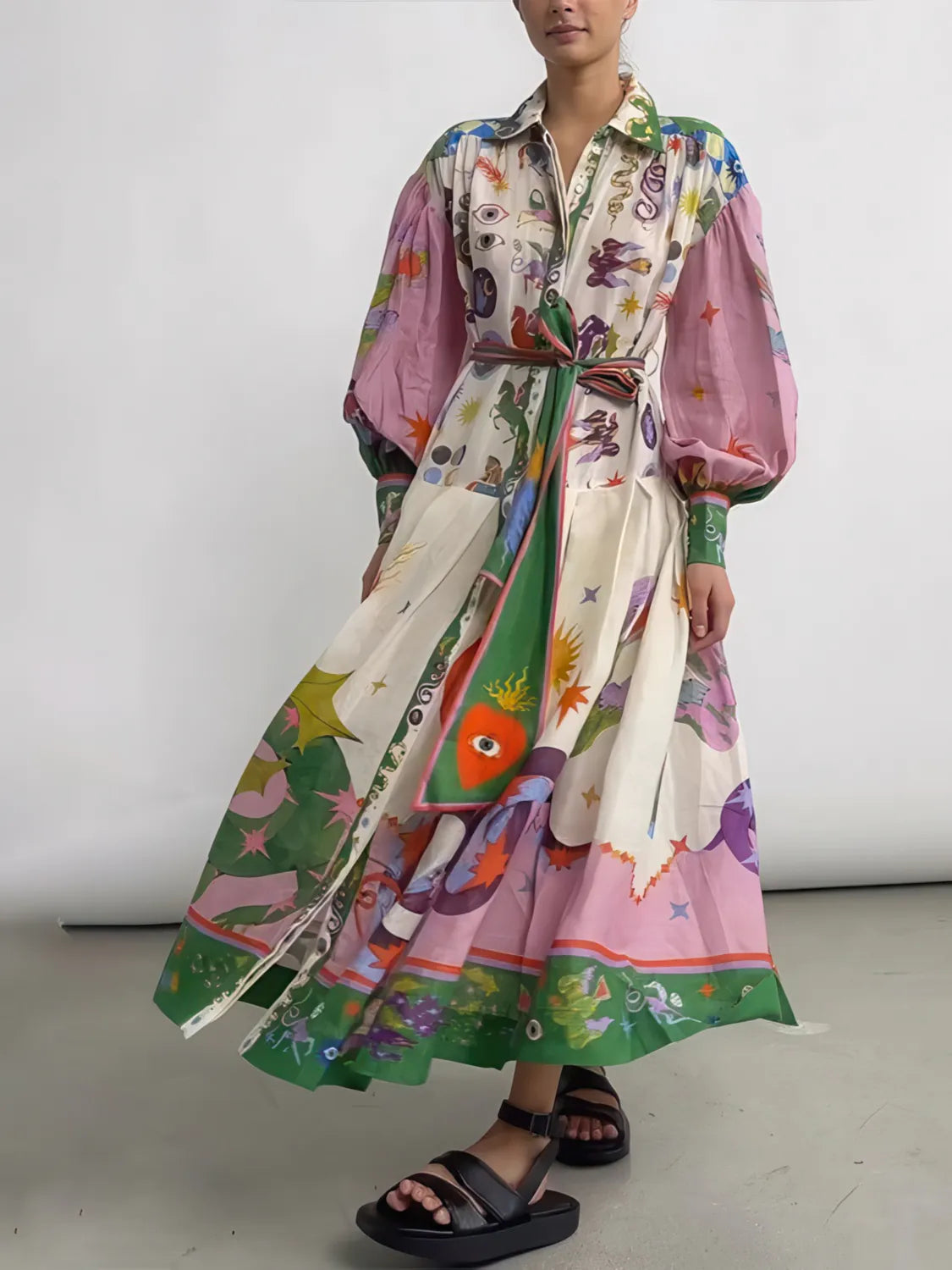 Person wearing a colorful patterned dress on a plain background. #Color_Violet