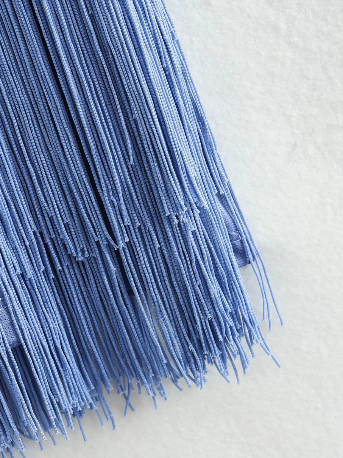 Close-up of blue tassels on a light background. #Addtl