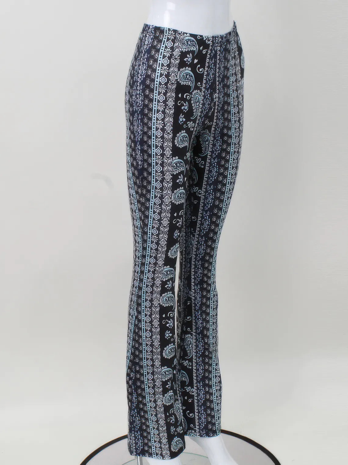 Black and white patterned pants on a mannequin against a white background. #Color_Black